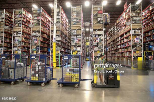 Workers pack and ship customer orders at the 750,000-square-foot Amazon fulfillment center on August 1, 2017 in Romeoville, Illinois. On August 2,...