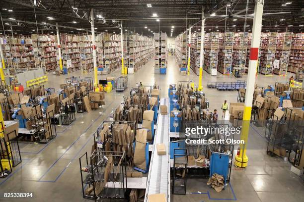 Workers pack and ship customer orders at the 750,000-square-foot Amazon fulfillment center on August 1, 2017 in Romeoville, Illinois. On August 2,...