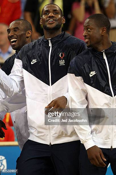 Kobe Bryant, LeBron James and Dwyane Wade of the United States wait to receive the gold medal after defeating Spain in the men's basketball final...