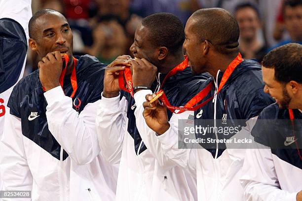 Kobe Bryant and Dwyane Wade of the United States bite their gold medals in men's basketball after defeating Spain during Day 16 of the Beijing 2008...
