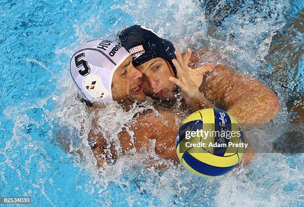 Tamas Kasas of Hungary battles with Tony Azevedo of the United States during the Men's Gold Medal Water Polo Match at the Yingdong Natatorium of...