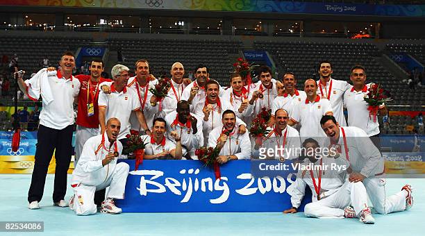 The Spain team pose with the bronze medals won during the Men's Handball compettition held at the National Indoor Stadium during Day 16 of the...