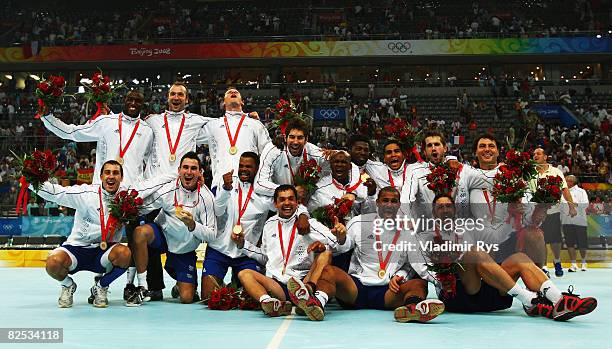 The France team celebrate after receiving the gold medals won during the Men's Handball competition held at the National Indoor Stadium during Day 16...