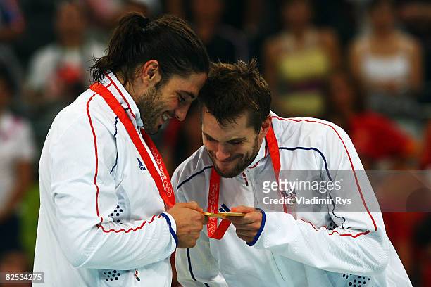 Bertrand Gille and Guillaume Gille of France look at their medals receiving the gold medals won in the Men's Handball competition held at the...