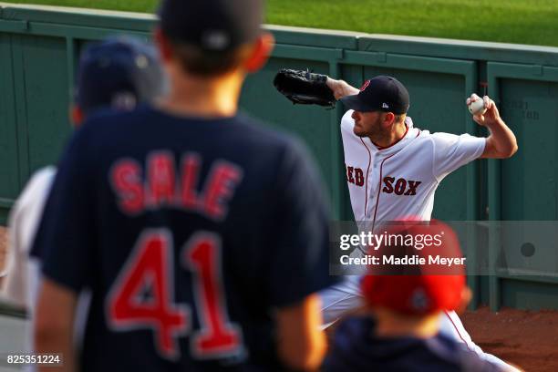 Young fans watch Chris Sale of the Boston Red Sox warm up in the bullpen before the game between the Red Sox and the Cleveland Indians at Fenway Park...