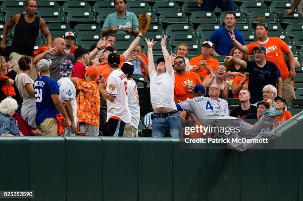 Alex Gordon of the Kansas City Royals is unable to catch a foul ball hit by Adam Jones of the Baltimore Orioles in the second inning during a game at...