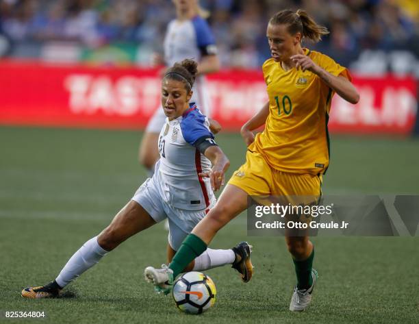 Emily Van Egmond of Australia dribbles against Carli Lloyd of the United States during the 2017 Tournament of Nations at CenturyLink Field on July...