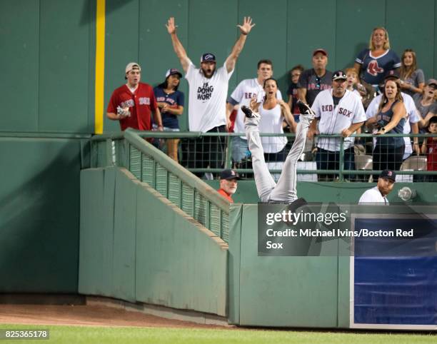 Austin Jackson of the Cleveland Indians flips over the bullpen wall after robbing Hanley Ramirez of the Boston Red Sox of a home run in the fifth...