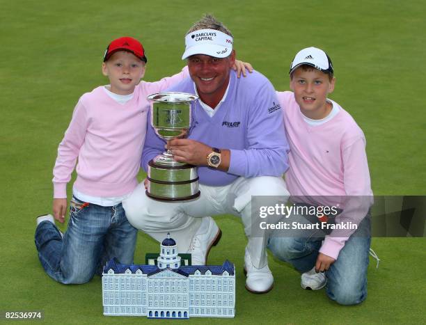 Darren Clarke of Northern Ireland celebrates with his sons Conor Clarke and Tyrone Clarke as he holds the trophy for winning The KLM Open at Kennemer...