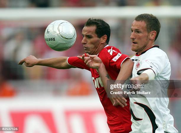 Petit of Koeln battles for the ball with Michael Fink of Frankfurt during the Bundesliga match between 1.FC Koeln and Eintracht Frankfurt at the...