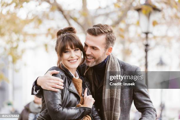 portrait of happy couple outdoors together - destination fashion 2016 stock pictures, royalty-free photos & images