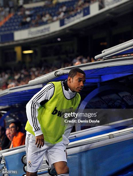 Robinho of Real Madrid takes his place on the substitutes bench before the start of the Super Copa Second Leg match between Real Madrid and Valencia...