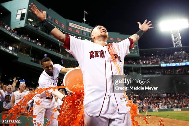 Xander Bogaerts of the Boston Red Sox dunks Christian Vazquez with Powerade after Vazquez hit a three run homer to defeat the Cleveland Indians 12-10...