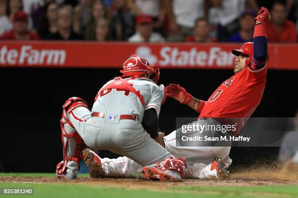 Yunel Escobar of the Los Angeles Angels of Anaheim is tagged out at home by Andrew Knapp of the Philadelphia Phillies during the third inning of a...