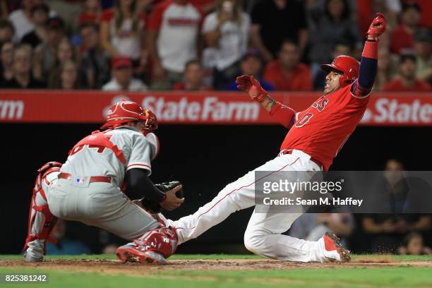 Yunel Escobar of the Los Angeles Angels of Anaheim is tagged out at home by Andrew Knapp of the Philadelphia Phillies during the third inning of a...