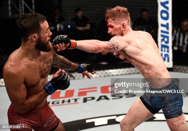 Austin Arnett punches Brandon Davis in their featherweight bout during Dana White's Tuesday Night Contender Series at the TUF Gym on August 1, 2017...