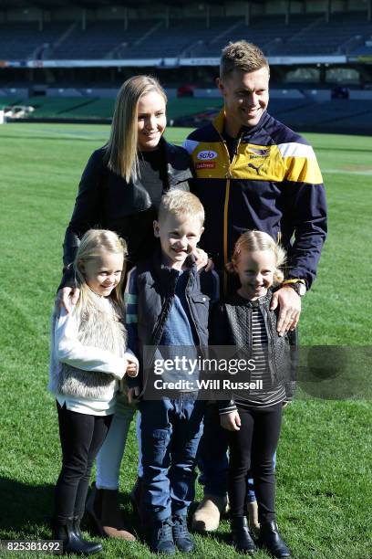 Sam Mitchell and family pose on the oval after speaking to the media announcing his retirement from playing at the end of the home and away season...