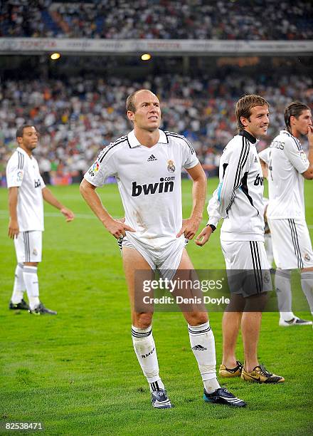 Arjen Robben of Real Madrid waits to receive the trophy after Real Madrid beat Valencia in the Super Copa Second Leg match between Real Madrid and...