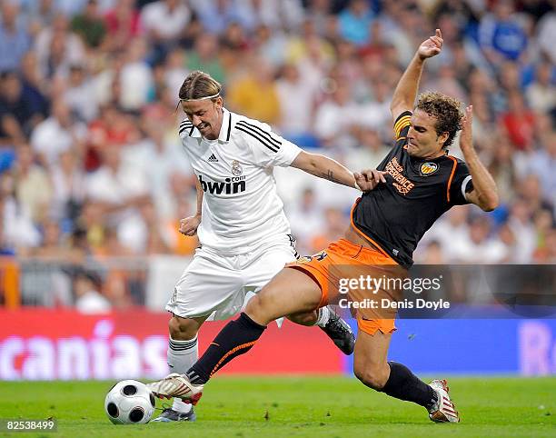 Guti of Real Madrid is tackled by Ruben Baraja of Valencia during the Super Copa Second Leg match between Real Madrid and Valencia at the Santiago...