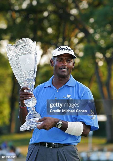 Vijay Singh of Fiji Islands holds the trophy after winning a two hole playoff during the final round of The Barclays at the Ridgewood Country Club...