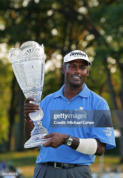 Vijay Singh of Fiji Islands holds the trophy after winning a two hole playoff during the final round of The Barclays at the Ridgewood Country Club...