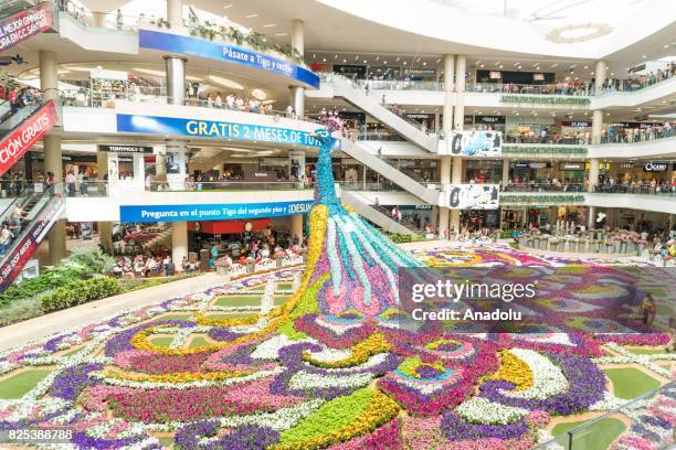 Three dimensional peacock figure, made of 182 thousand flowers with the height of 12 meters, is displayed during the Festival of the Flowers at the...