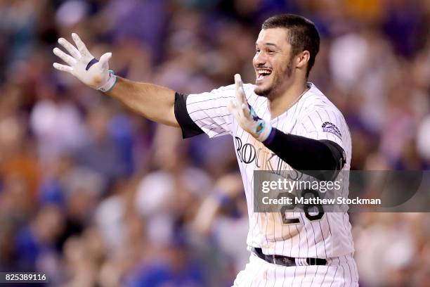 Nolan Arenado of the Colorado Rockies celebrates after driving in the game winning run in the ninth inning against the New York Mets at Coors Field...