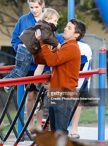 Crown Prince Frederik of Denmark plays with his children Prince Christian and Princess Isabella, and family members at a local Hobart park on August...