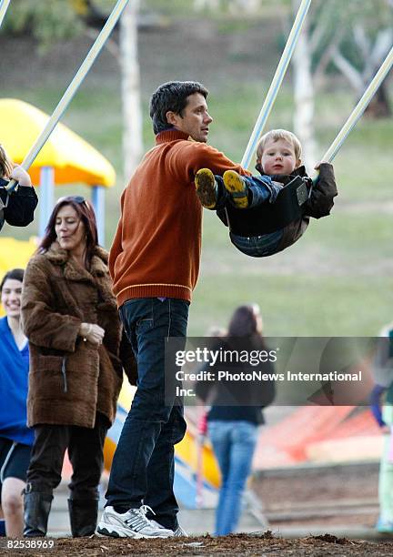 Crown Prince Frederik of Denmark plays with his children Prince Christian and Princess Isabella, and family members at a local Hobart park on August...