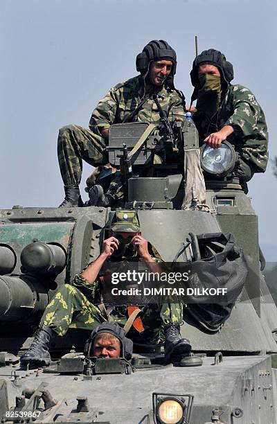 Russian soldiers sit atop of a tank as they leave the flashpoint city of Gori on August 22 en route towards the South Ossetian capital Tskhinvali....