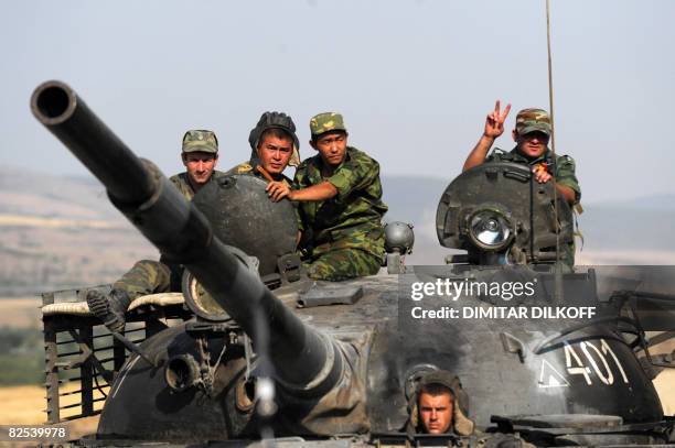 Russian soldier shows a V-sign as his tank leaves a checkpoint on the Gori-Tbilisi road near the village of Khurvaleti on August 22 on their way...