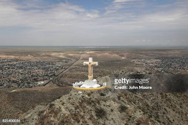 Statue Christ of the Rockies overlooks the U.S.-Mexico border on August 1, 2017 as seen from a U.S. Customs and Border Protection helicopter near...