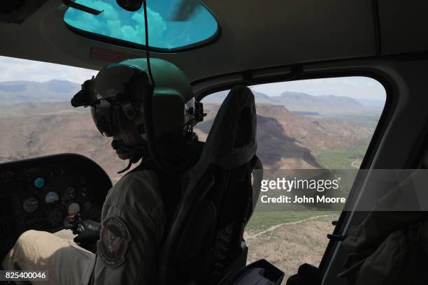 Customs and Border Protection pilot flies a helicopter patrol along the U.S.-Mexico border on August 1, 2017 near Lajitas, Texas. Logistical...