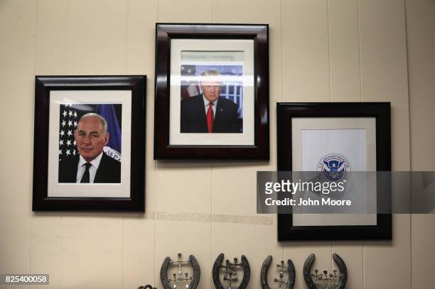 Portrait of President Donald Trump and his chief of staff John Kelly hang on the wall of a U.S. Air and Marine Operations , office on August 1, 2017...