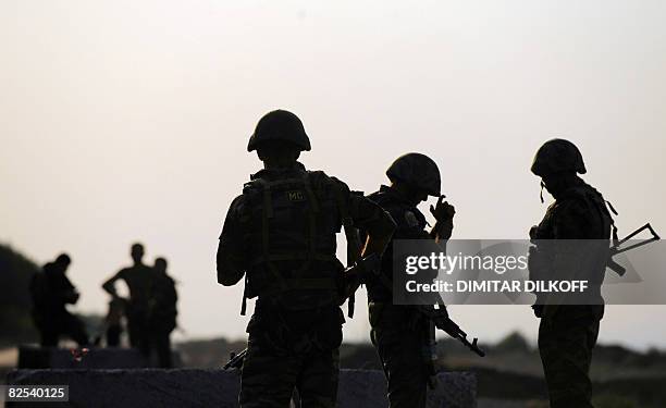 Russian peacekeepers block the Gori-Tbilisi road during the final moments of the forces' pull-out on August 22 near the village of Khurvaleti....