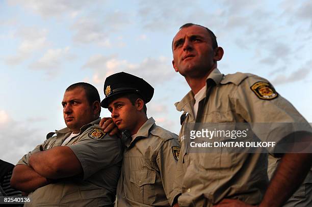 Georgian policemen wait at the last checkpoint on the Gori-Tbilisi road near the village of Khurvaleti on August 22, 2008. Georgian police are back...