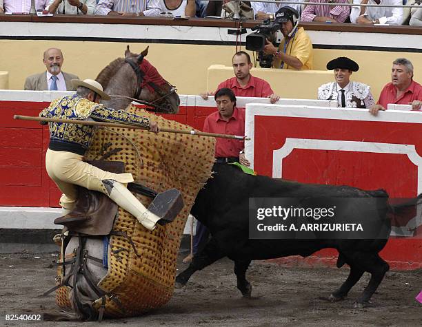 French picador Jacques Monnier falls after being knocked down by a Fuente Ymbro fighting bull during the seventh corrida of the Aste Nagusia...