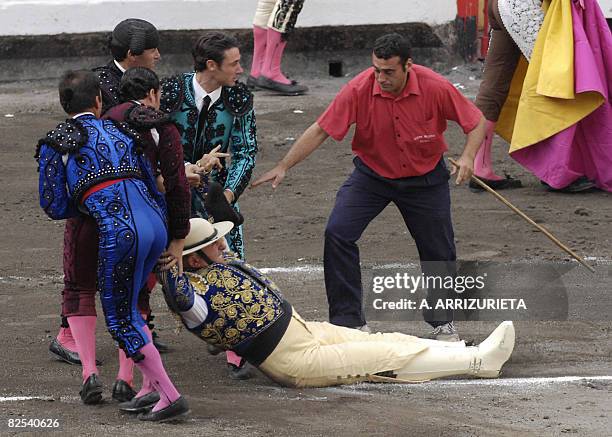 Some toreros help French picador Jacques Monnier after he was knocked down by a Fuente Ymbro fighting bull during the seventh corrida of the Aste...