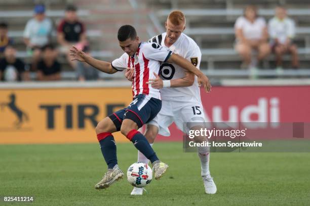 Chivas U-20s midfielder Ivan Gutierrez and MLS Homegrown and Real Salt Lake defender Justen Glad battle for the ball during a soccer match between...