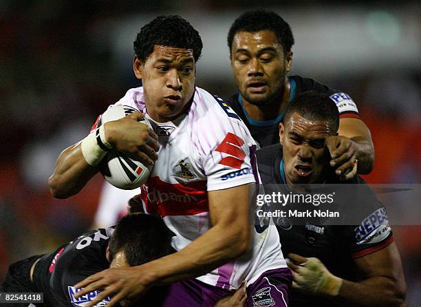 Israel Folau of the Storm takes on the Panthers defence during the round 24 NRL match between the Penrith Panthers and the Melbourne Storm held at...