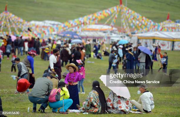Tibetans and tourists attend a tent festival on a grassland 4,500 meters above sea level on August 1, 2017 in Shiqu County, , Sichuan Province of...