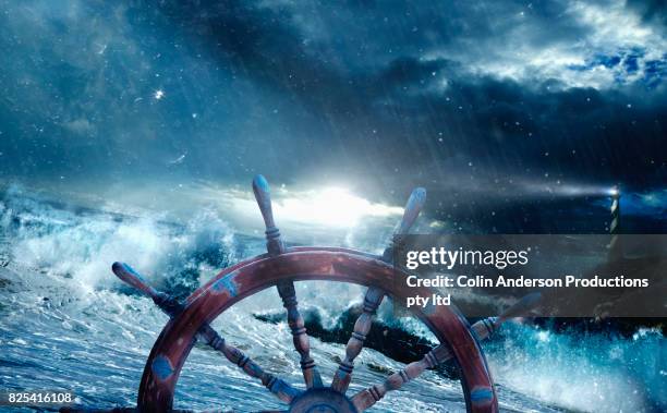 guiding light in troubled waters - rudder stock pictures, royalty-free photos & images