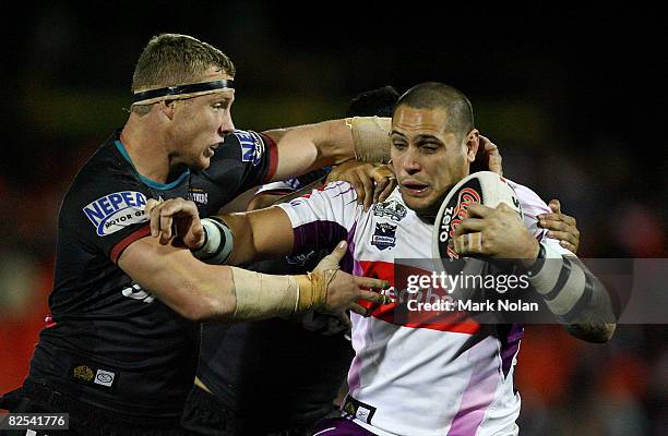 Nathan Smith of the Panthers tackles Jeremy Smith of the Storm during the round 24 NRL match between the Penrith Panthers and the Melbourne Storm...