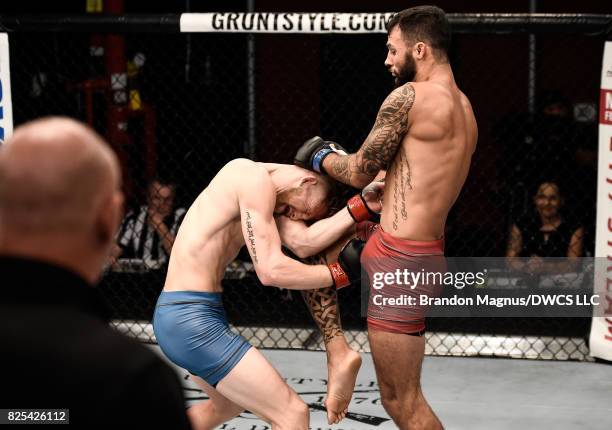 Brandon Davis knees Austin Arnett in their featherweight bout during Dana White's Tuesday Night Contender Series at the TUF Gym on August 1, 2017 in...