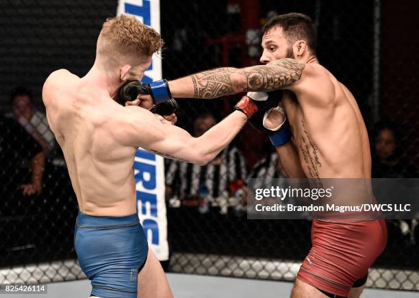 Brandon Davis punches Austin Arnett in their featherweight bout during Dana White's Tuesday Night Contender Series at the TUF Gym on August 1, 2017...