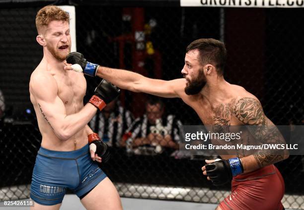 Brandon Davis punches Austin Arnett in their featherweight bout during Dana White's Tuesday Night Contender Series at the TUF Gym on August 1, 2017...