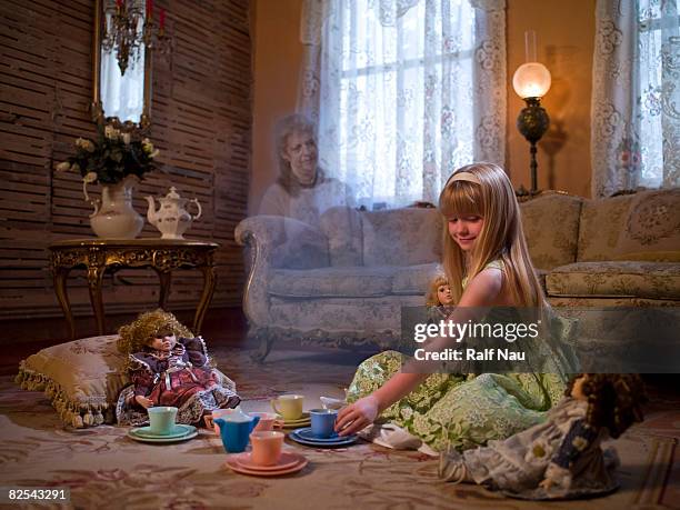 young girl having tea party with dolls - ghost player foto e immagini stock