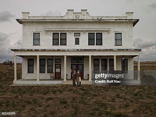 cowboys standing back to back with pistols - montana western usa stock pictures, royalty-free photos & images