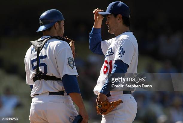 Pitcher Chan Ho Park and catcher Russell Martin of the Los Angeles Dodgers talk on the mound during the game against the Milwaukee Brewers on August...