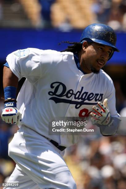 Manny Ramirez of the Los Angeles Dodgers runs the bases after hitting a two run home run in the first inning against the Milwaukee Brewers on August...